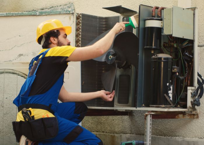 HVAC technician using AI technology on a service job