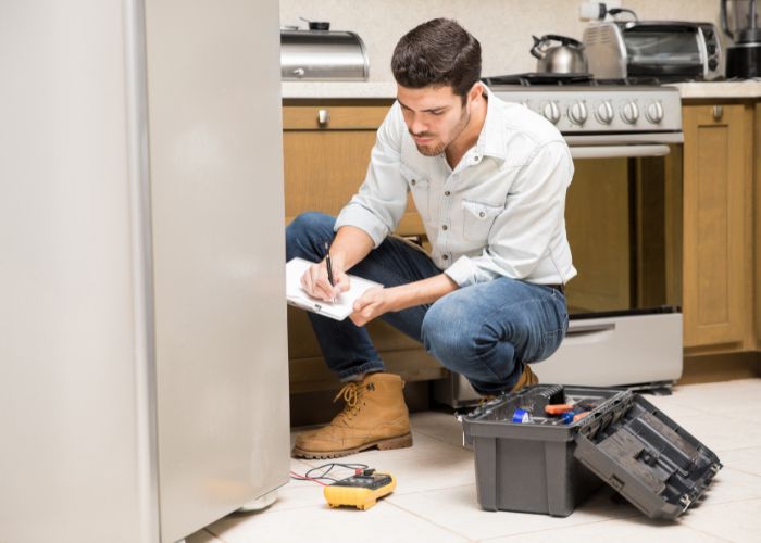 Refrigeration technician using AI tools on a service job